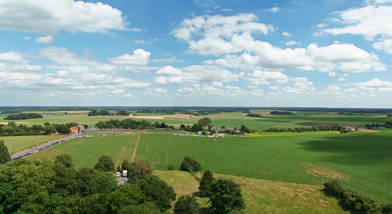 View of beautiful agricultural fields with clear blue sky in England