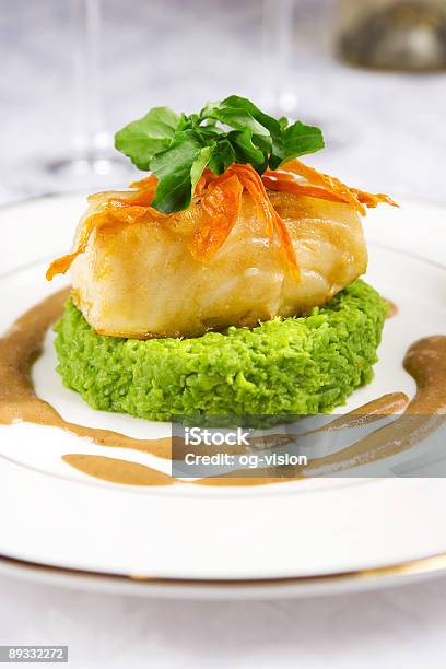 Small Piece Of Sea Bass With Condiments On A White Plate Stock Photo - Download Image Now