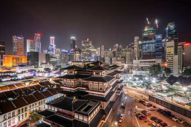 istock Buddha Tooth Relic Temple and Singapore Skyline 893323872