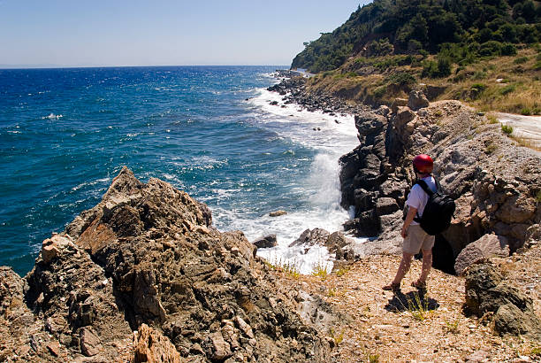 istock Hiker on a rock above the sea 89335128