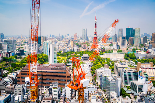 Aerial view of cranes in a construction site in downtown Tokyo.