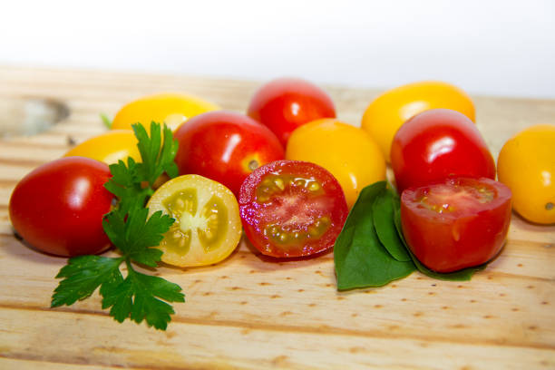 red and yellow cherry tomatoes on wooden background