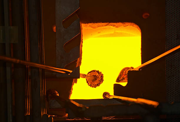 Incandescent piece of glass melted in the furnace. The melting pot with liquid glass is visible inside the furnace along with fire.