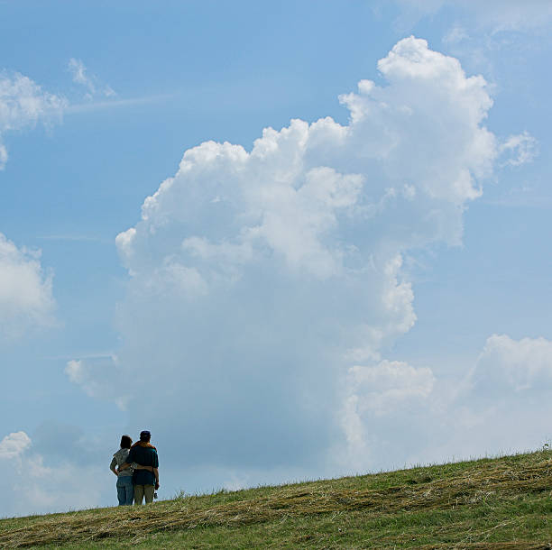 istock Loving couple on dyke looking at majestic cloudscape 89337372