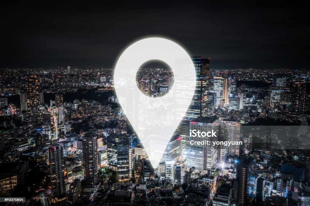 Tokyo as a Travel Destination Symbol of a pin on the background of Tokyo cityscape. Building Exterior Stock Photo