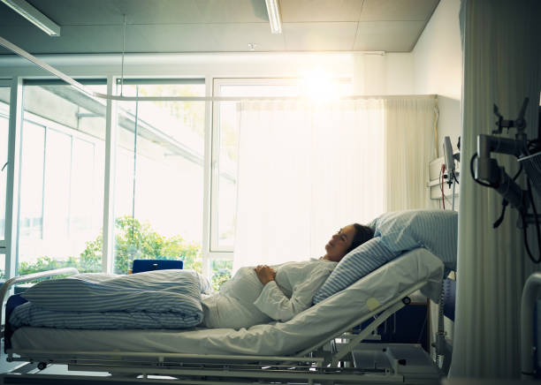 Time to close my eyes for a bit Shot of a tired young woman lying down on a bed and resting inside of a hospital maternity ward stock pictures, royalty-free photos & images