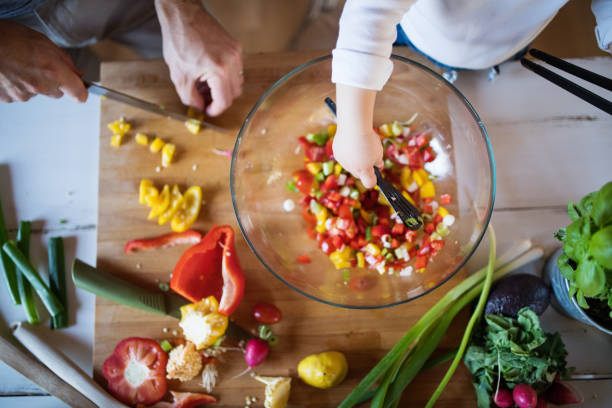 istock Young father with a toddler boy cooking. 893385476