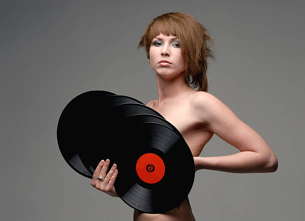 Naked girl covered with records horizontal view  uncompromising stock pictures, royalty-free photos & images