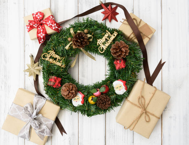 istock Christmas wreath decorative with gift boxes,star,pine cones on white wooden background,flat lay 893392866