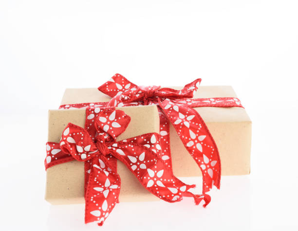 istock Christmas brown gift boxes wrapped with red ribbon isolated on white background 893395064