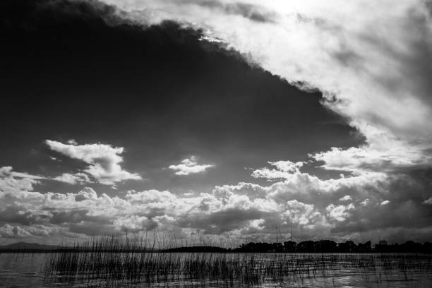 istock A cloudscape over a lake, with plenty of empty space between the clouds 893395288