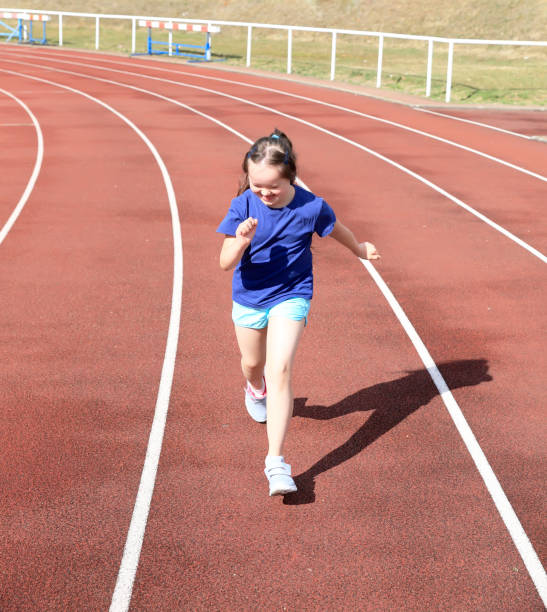 istock Little girl have fun on the stadium 893401072