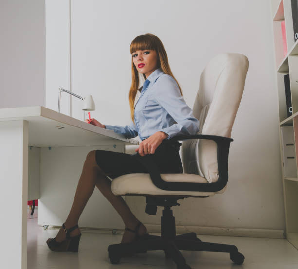 istock girl Secretary sits behind the Desk 893403272