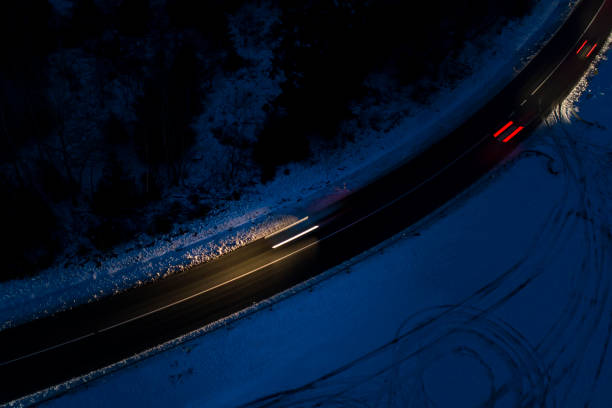 istock Road through wintery forest - aerial view 893404444