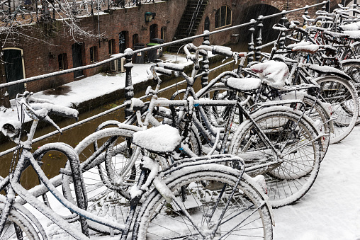 Bike along the canals in Utrecht in a winter snow storm, Netherlands.