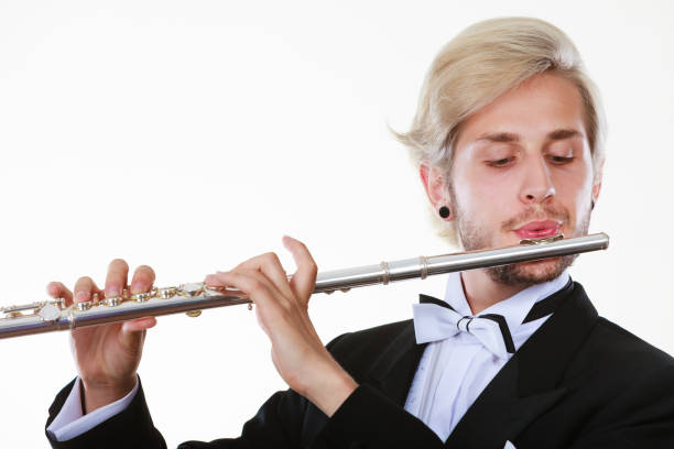 istock Male flutist wearing tailcoat plays flute 893407018