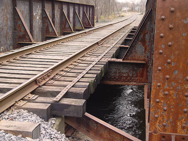 Railroad Track Tressel over River Railroad track tressel over river in rural Amercian setting.     tressle stock pictures, royalty-free photos & images