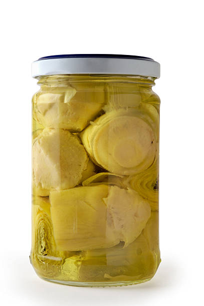 a pile of marinated artichoke hearts on a white background