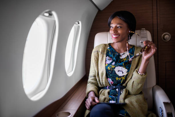 istock Woman in private jet airplane 893412608