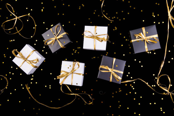 istock Black and white gift boxes with gold ribbon on shine background. Flat lay. 893419662