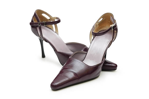 A front view of two pink high heel pumps with bows. Shallow DOF.