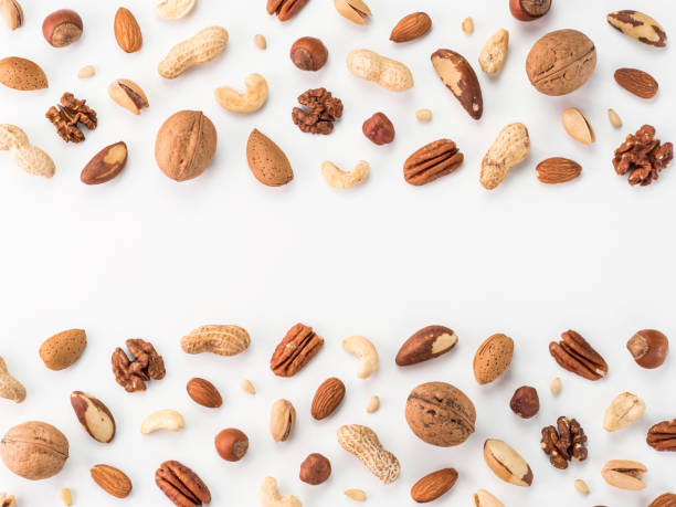 Pattern of nuts, isolated on whie Pattern of nuts mix with copy space. Various nuts isolated on white. Pecan, macadamia, brazil nut, walnut, almonds, hazelnuts, pistachios, cashews, peanuts, pine nuts. Top view or flat-lay. Copy space isolated on whie stock pictures, royalty-free photos & images