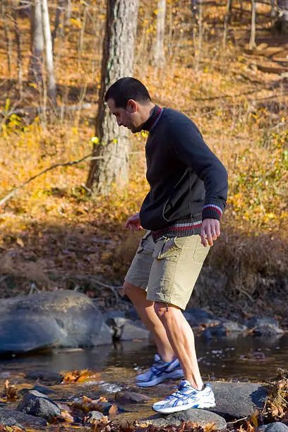 Photo of River crossing from one stone to another