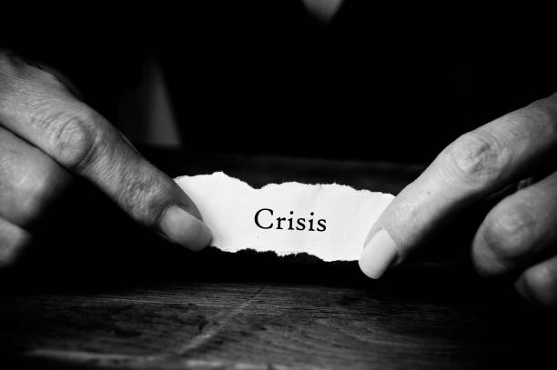 istock Concept message on paper in hands - crisis 893428024