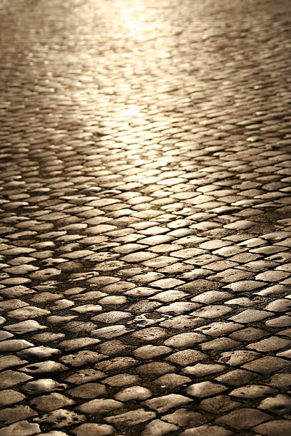 istock A cobblestone street with a light shining 89342986