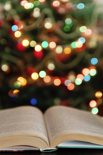 istock Christmas and bible with blurred candles light background 893430050