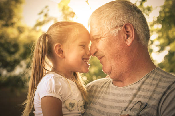 istock Granddaughter and grandfather share love. 893430654