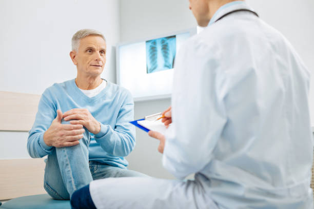 istock Good looking aged man holding his knee 893439760
