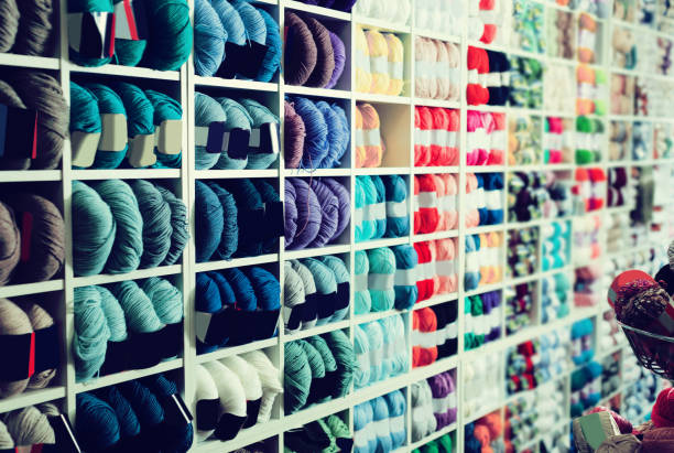 istock Shelves with various knitting yarn is staying 893440562