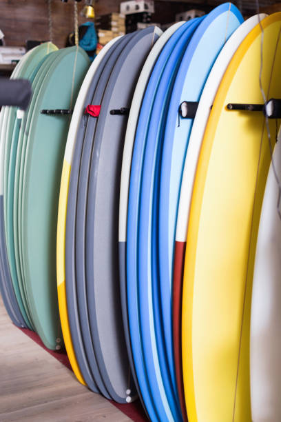 istock Image of colorful surfboard standing in store 893440564