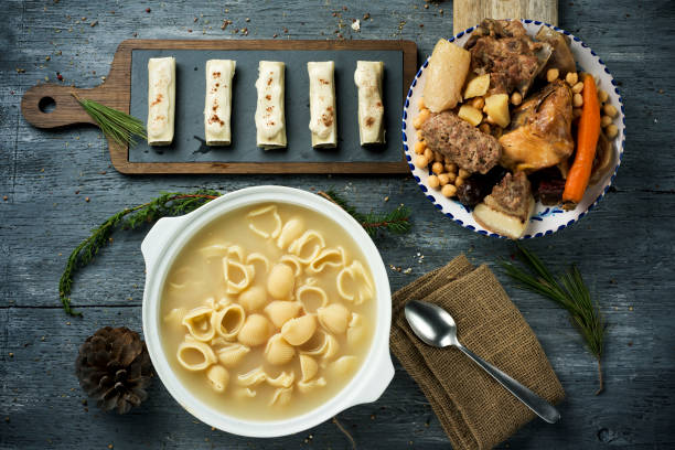 canelons and escudella typical of Catalonia, Spain canelons, sopa de galets or escudella de Nadal, and carn dolla, cannelloni, soup with galets pasta and the meat and vegetables used in the broth, typically eaten on Christmas in Catalonia, Spain catalonia stock pictures, royalty-free photos & images