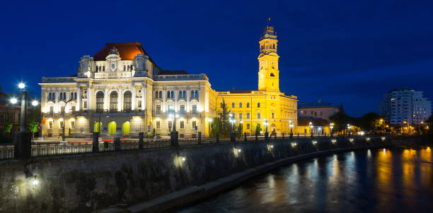 istock Oradea City Hall on embankment in twilight 893440822