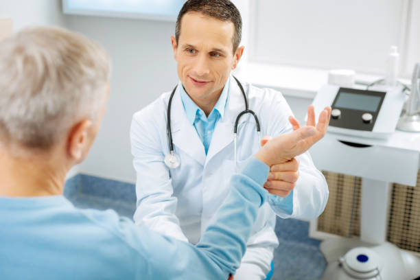 istock Nice positive doctor speaking to the patient 893443606