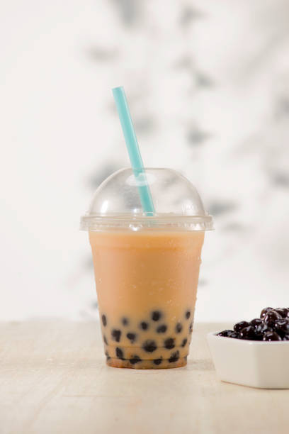 istock Homemade milk bubble tea in plastic cups on table. 893444024