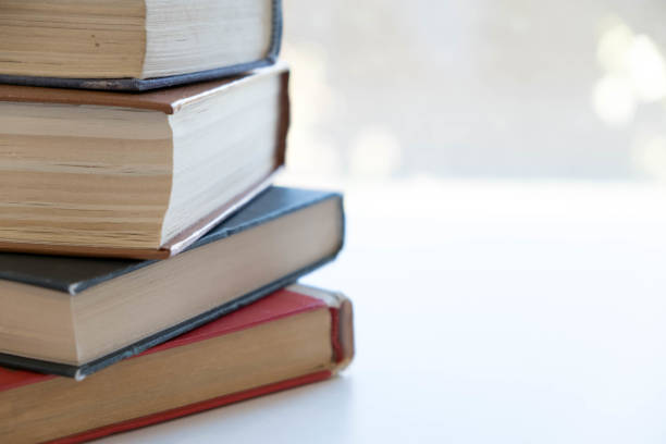 istock Book stack in the library room and blurred bookshelf, business and education background 893444674