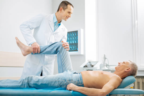 istock Cheerful delighted man lying on the massage bed 893449190