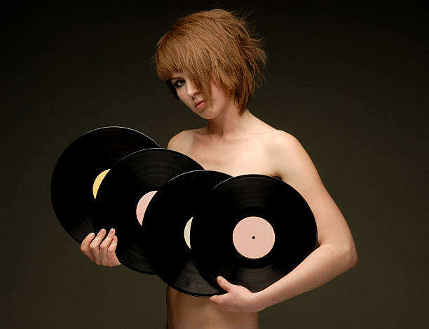 Naked girl with records looking straight olive background horizontal view  uncompromising stock pictures, royalty-free photos & images
