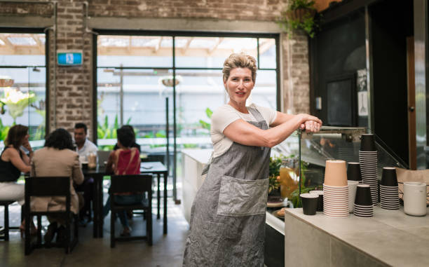 istock Woman with confidence standing in cafe. 893458990