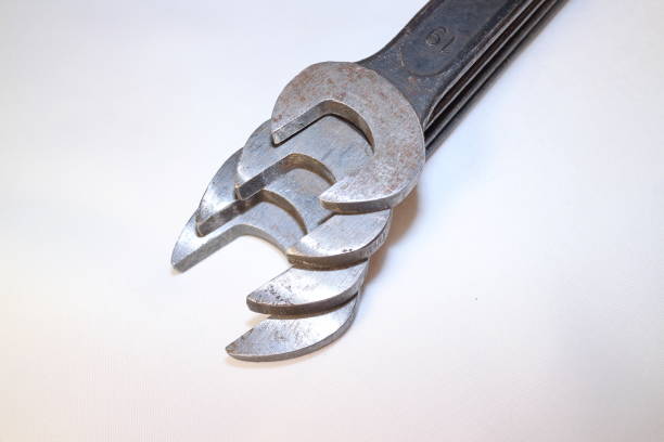 tools for work, four steel spanners in different positions on a white background