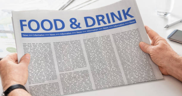 istock Man reading newspaper with the headline Food and Drink 893461068