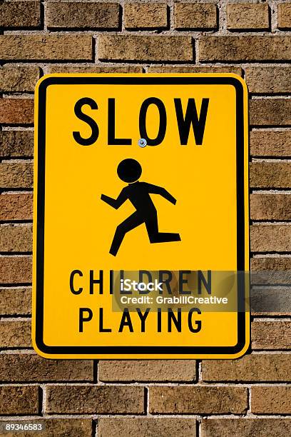 Children Playing Sign On Brick Wall Stock Photo - Download Image Now - Brick, Brick Wall, Childhood