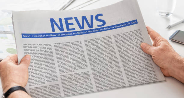 istock Man reading newspaper with the headline News 893469468
