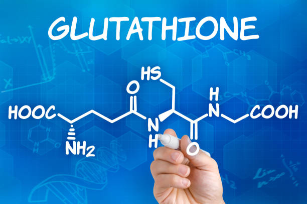 Hand with pen drawing the chemical formula of Glutathione stock photo