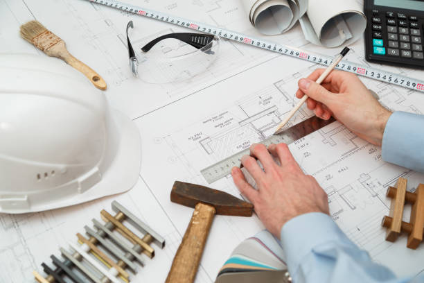 istock Image of engineer or architectural project, Close up of engineer's hand drawing plan on BluePrint with Engineering tools on workplace. 893478652