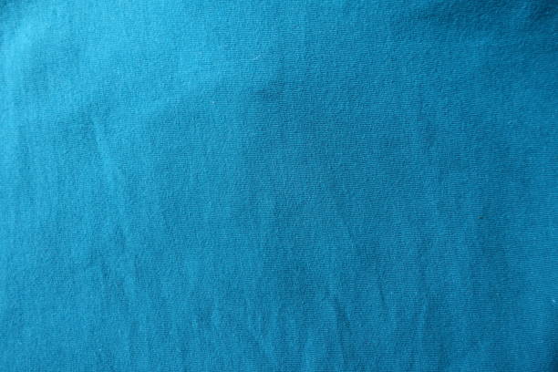 istock Surface of blue green fabric from above 893486494
