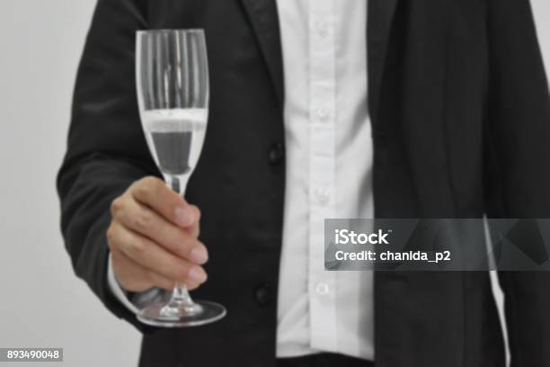 The Background Blur A Businessman Holding A Wine Glass Standing Posture Stock Photo - Download Image Now